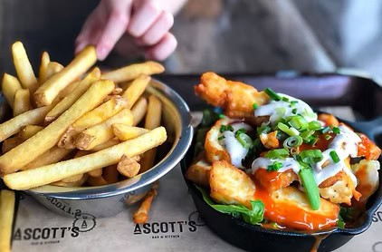 Classic fish and chips served with crispy fries at Ascotts Restaurant, Bromsgrove.