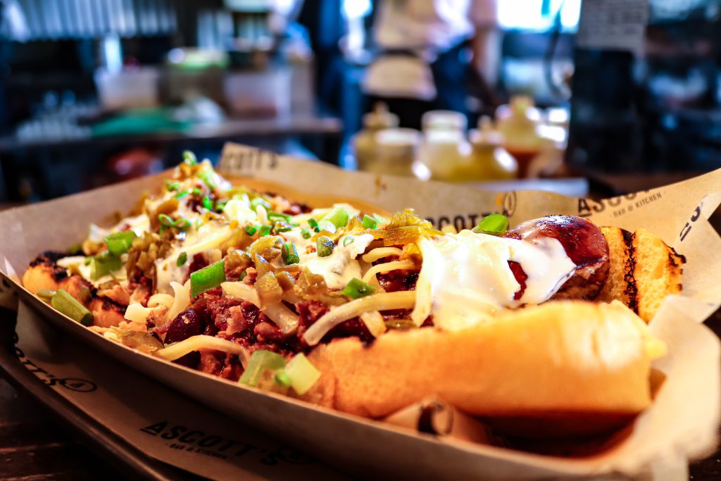 Delicious grilled hot dog with toppings and condiments at Ascotts Restaurant.