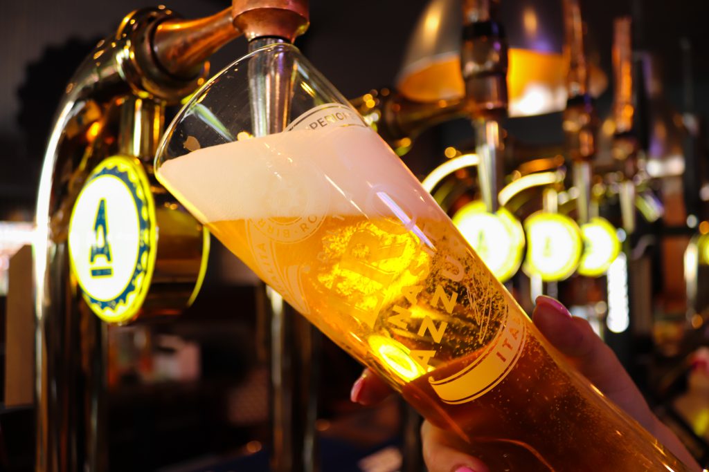 Beer pouring at Ascotts Restaurant, Bromsgrove, showcasing a lively pub atmosphere.