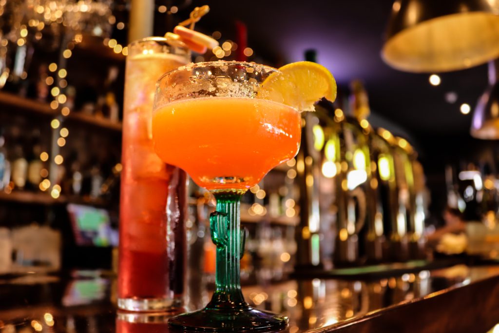 Vibrant cocktail served at Ascotts Restaurant in Bromsgrove, featuring fresh citrus and colourful pr.