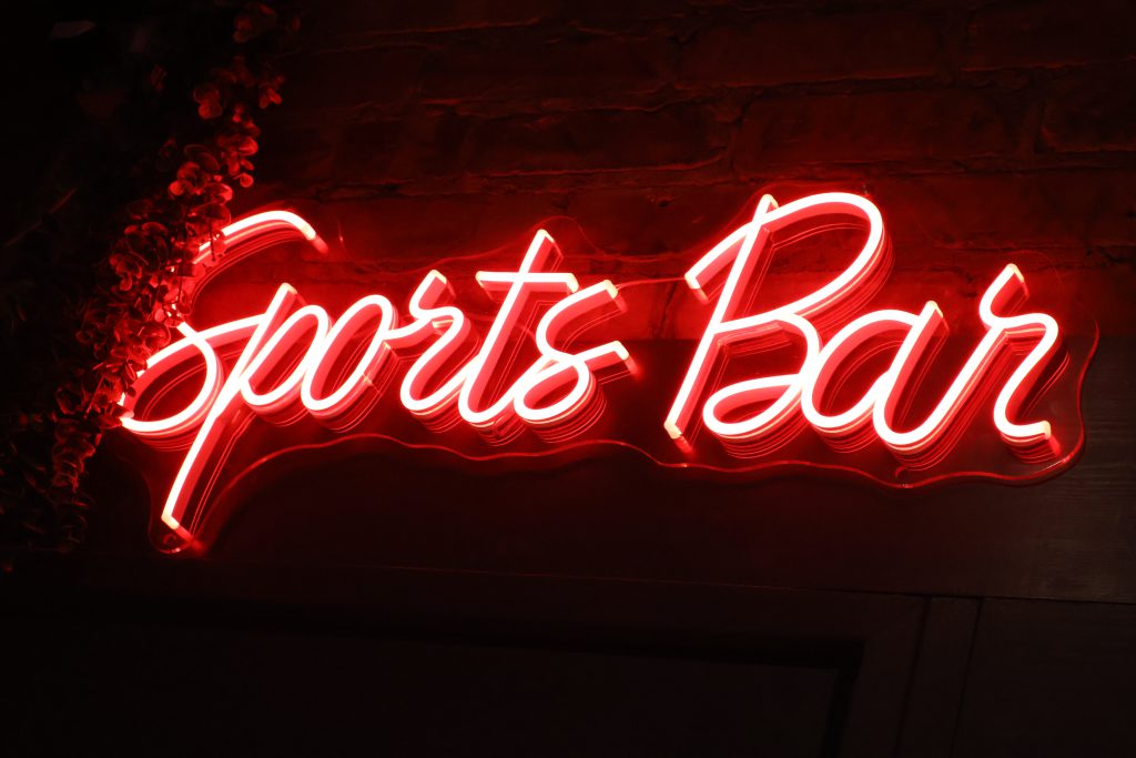 Sports Bar sign illuminated in red neon at Ascotts Bromsgrove, perfect for private hire events and s.